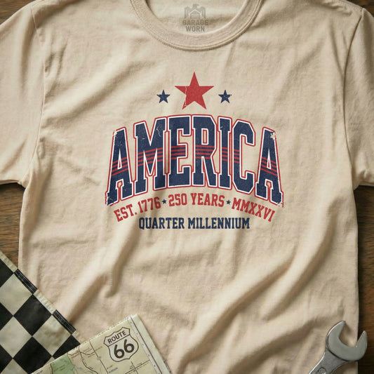 Cream t-shirt with "America Est. 1776 250 Years Quarter Millennium" graphic.
