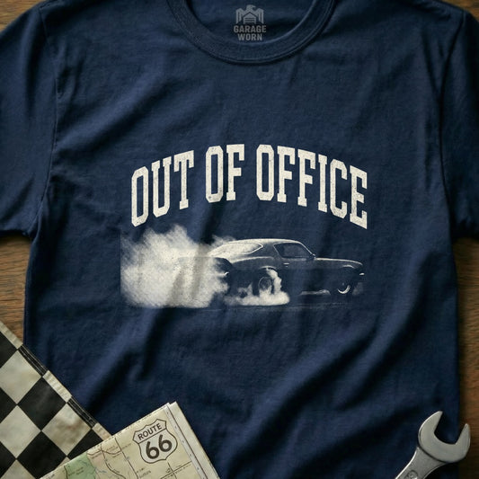 Navy t-shirt with "Out of Office" graphic and smoking car.