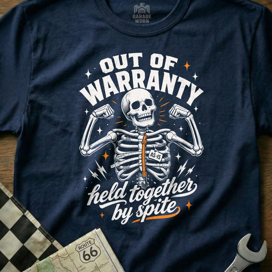Navy t-shirt with skeleton graphic reading "Out of Warranty, Held Together by Spite".