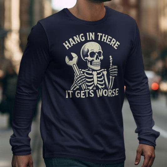 Skeleton with wrench and thumb up on dark blue long sleeve shirt, text reads "Hang In There It Gets Worse".
