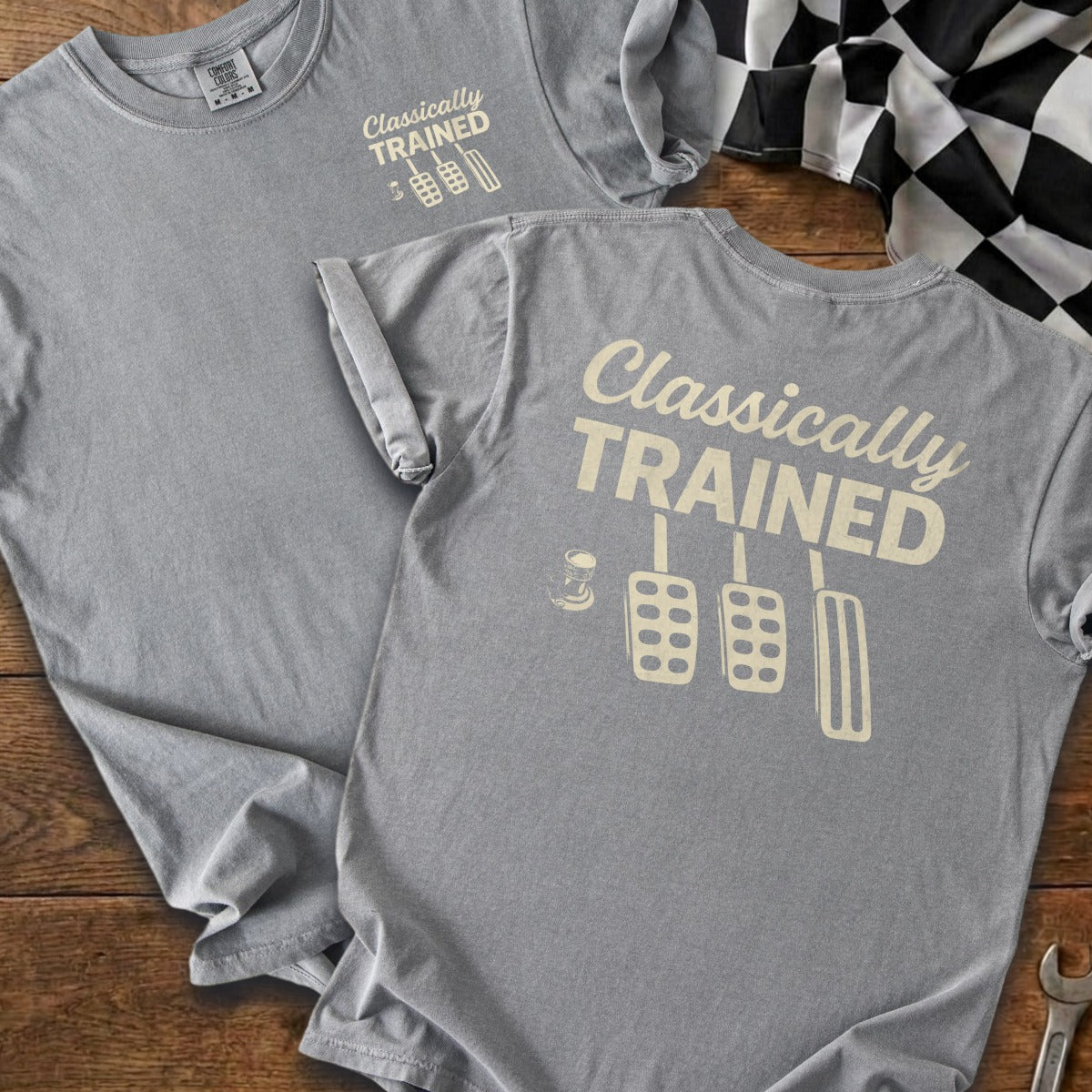 Light grey t-shirt with "Classically TRAINED" and pedal icons printed in beige.