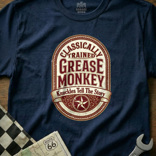 Navy t-shirt with "Classically Trained Grease Monkey" text and star emblem.