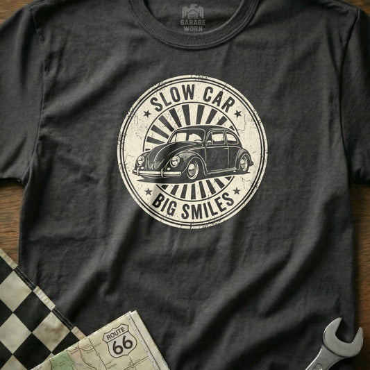 Dark gray t-shirt with "Slow Car, Big Smiles" text and a vintage Volkswagen Beetle.