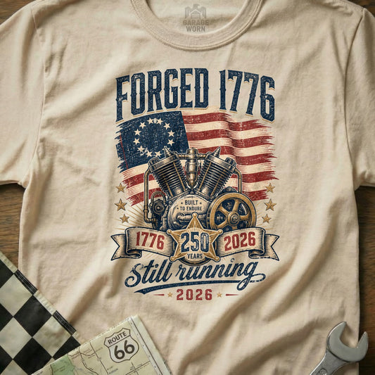 Forged 1776 t-shirt graphic with motorcycle engine and American flag, celebrating 250 years.