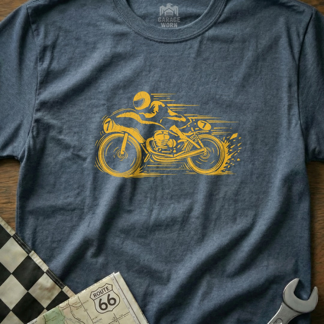 Yellow motorcycle racer graphic on a dark blue t-shirt with checkered flag and map.
