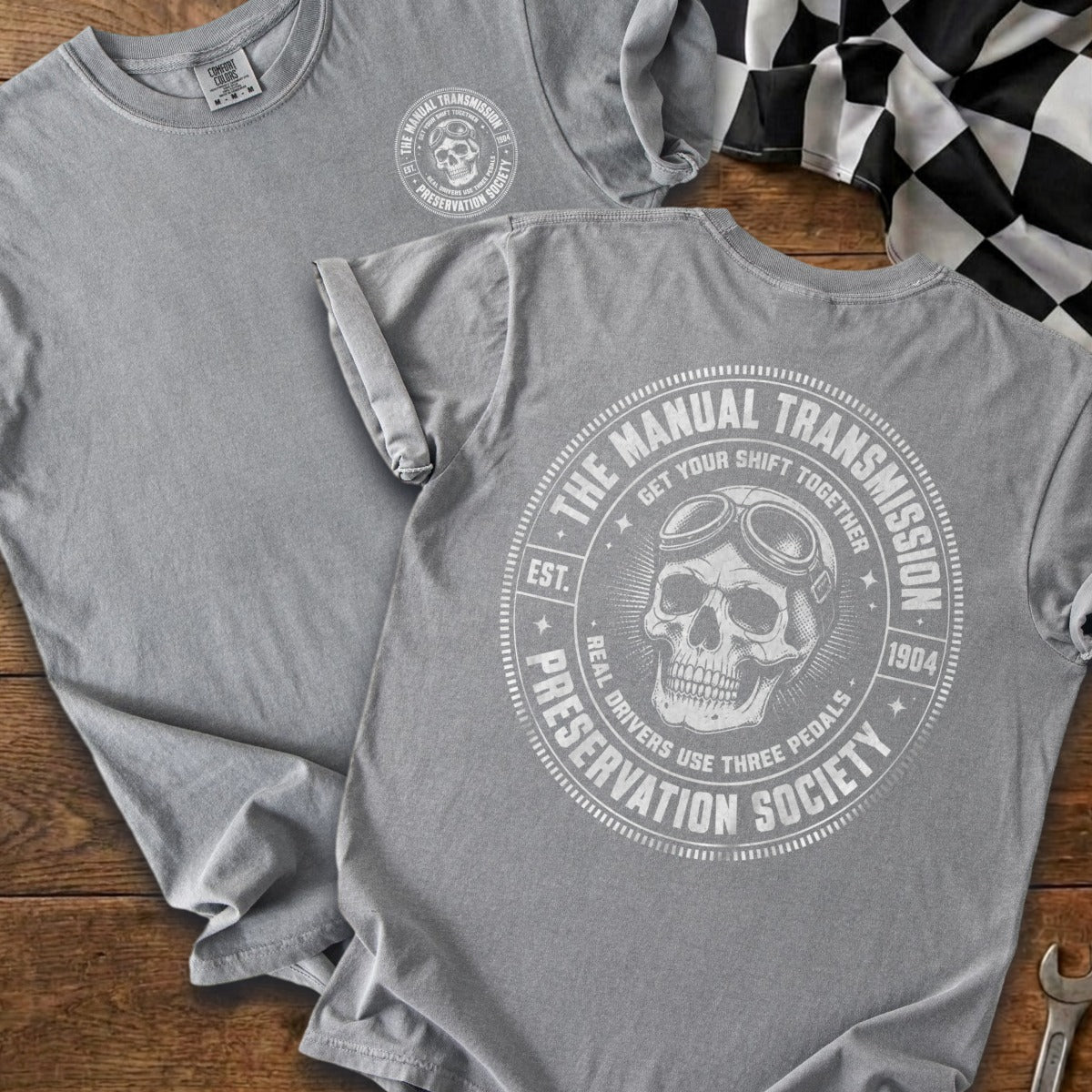 Gray t-shirt with a skull graphic and "The Manual Transmission Preservation Society" text.