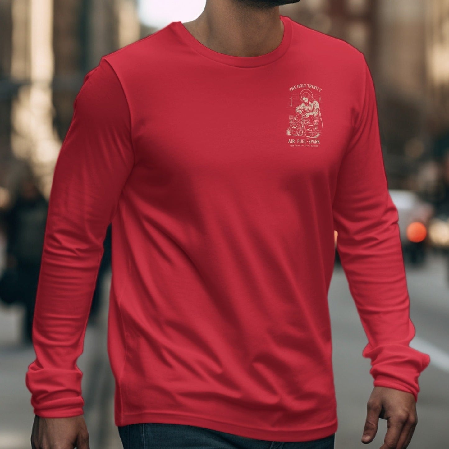 Red long-sleeve shirt featuring "The Holy Trinity" graphic with motorcycle parts and text.