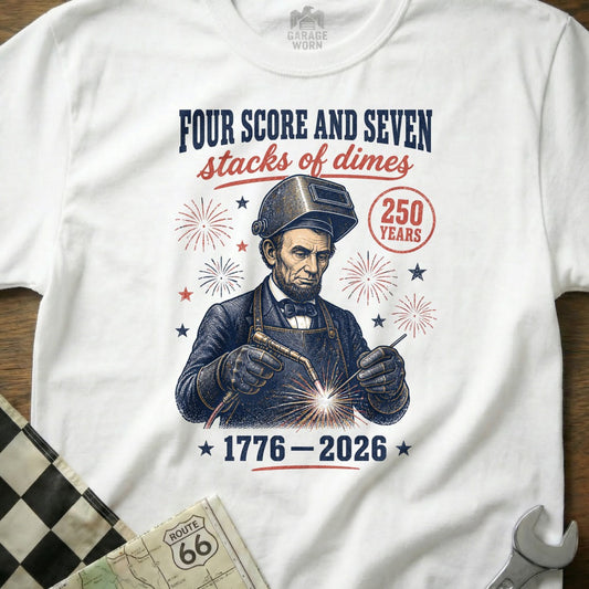 Abraham Lincoln welding with text "Four Score and Seven Stacks of Dimes 1776-2026".