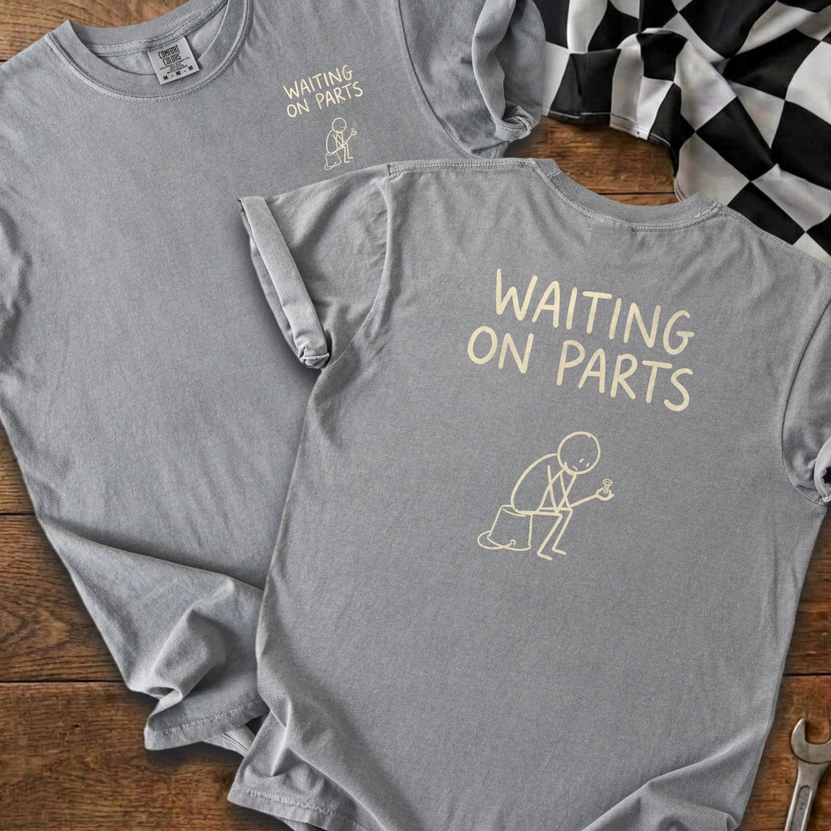 Gray t-shirts with "Waiting On Parts" text and a stick figure holding a bolt.