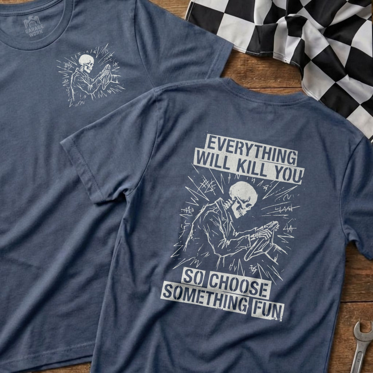 Navy t-shirt with a skeleton driver and text: "Everything will kill you, so choose something fun."