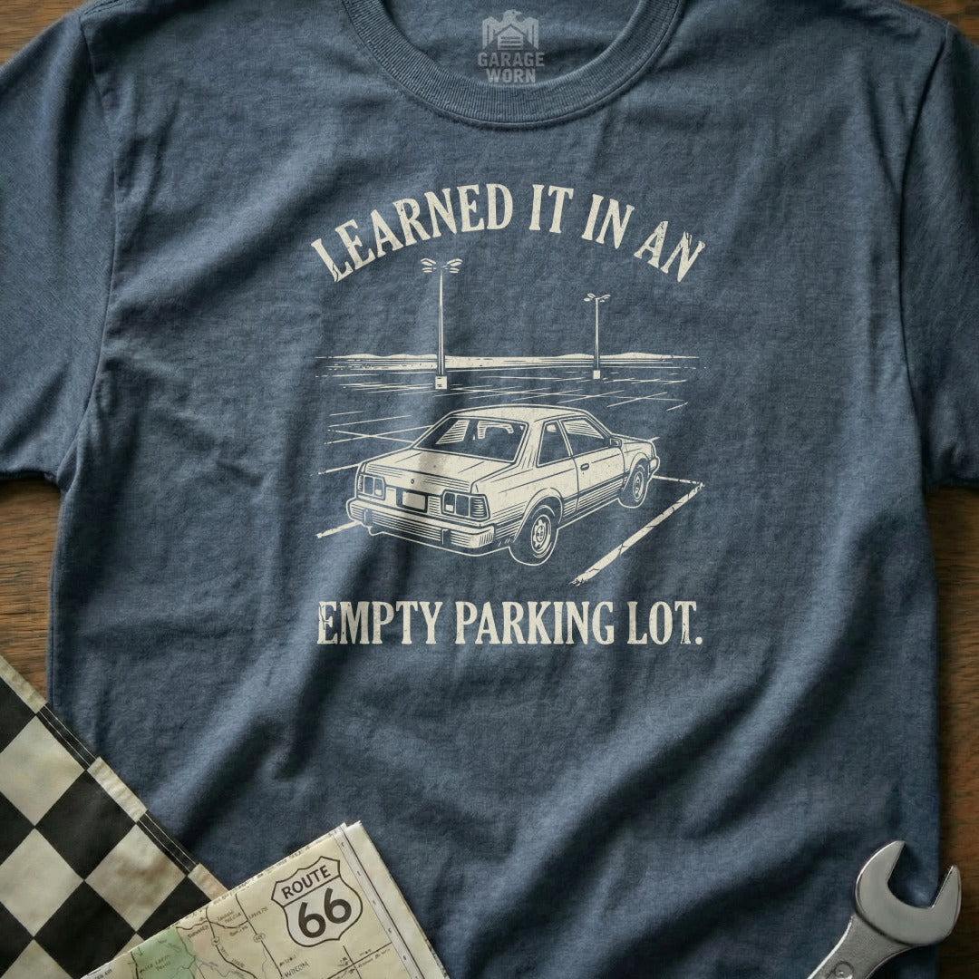 T-shirt with text "Learned it in an empty parking lot" and a car graphic.