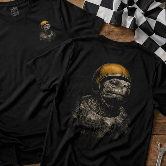 Black t-shirt with detailed print of a turtle wearing a yellow racing helmet.