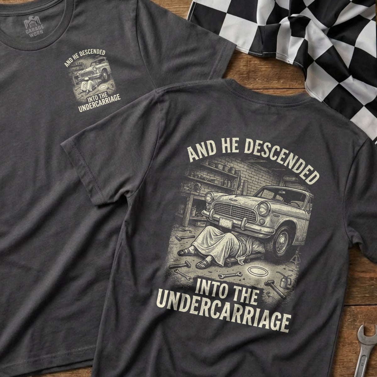 Dark grey t-shirt with "AND HE DESCENDED INTO THE UNDERRCARRIAGE" and graphic.