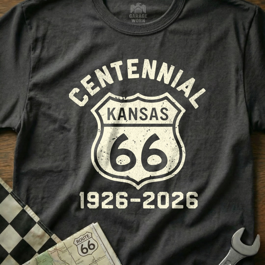Black t-shirt with white "Centennial Kansas 66 1926-2026" text on a Route 66 shield.
