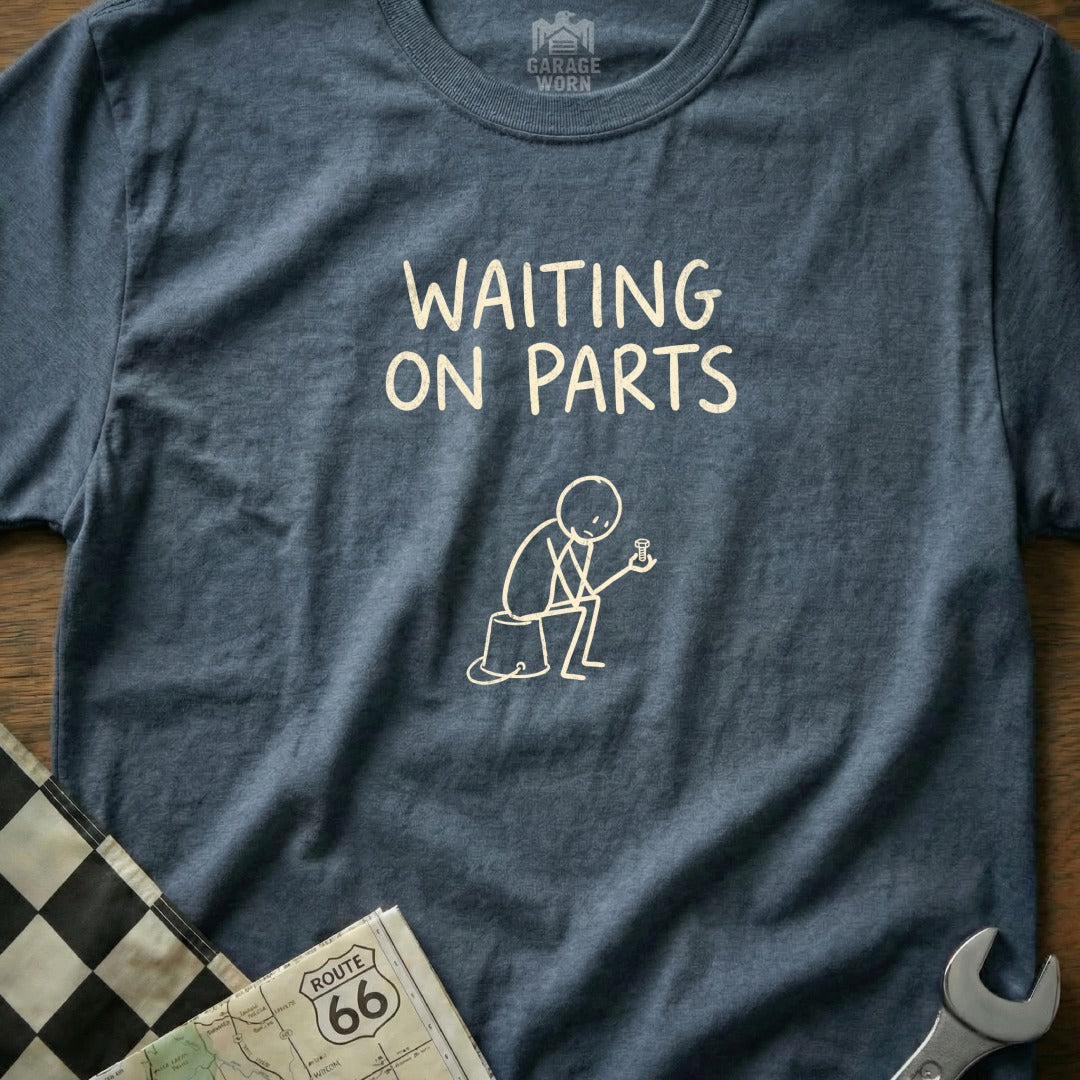 T-shirt with "WAITING ON PARTS" text and stick figure holding a bolt.
