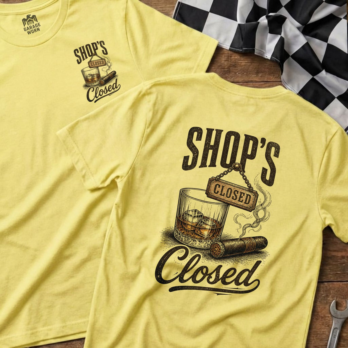 Yellow t-shirt with "SHOP'S CLOSED" graphic of a whiskey glass and cigar.