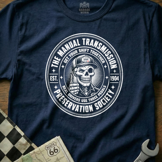 Navy t-shirt featuring a circular graphic about manual transmissions and skeletons.