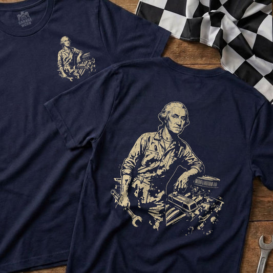 George Washington leaning on car engine with tools on dark blue t-shirt.