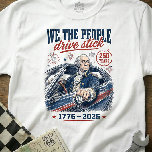 George Washington driving a stick shift car, text "WE THE PEOPLE drive stick 250 YEARS 1776-2026".
