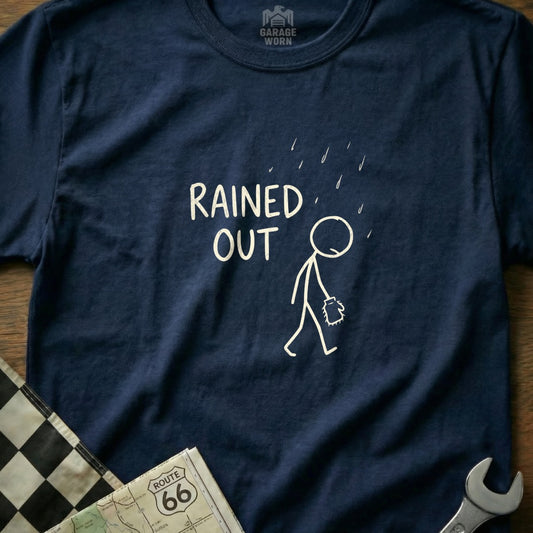 Navy t-shirt with "RAINED OUT" text and stick figure walking in rain.