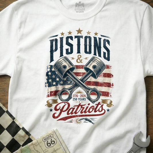 White t-shirt with "Pistons & Patriots" and crossed pistons graphic.