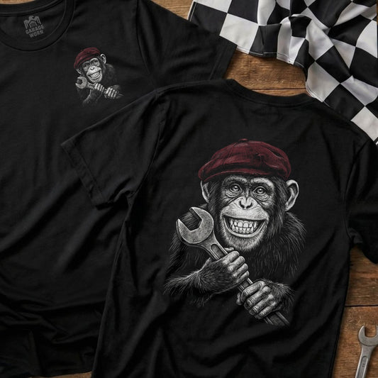 Black t-shirt with illustration of a smiling chimpanzee holding a wrench.