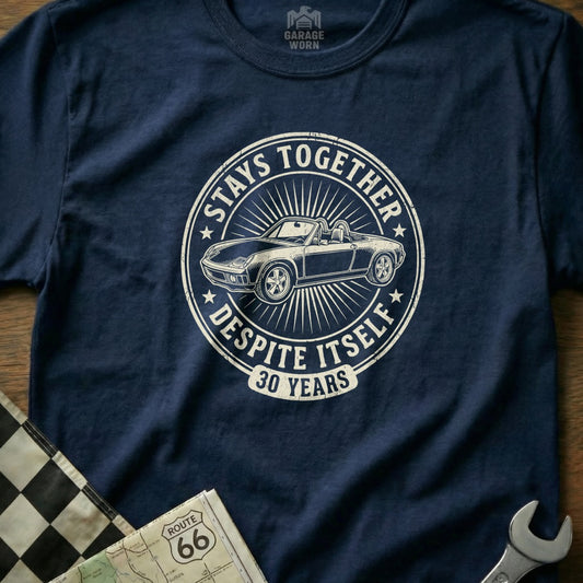 Navy t-shirt with white circular graphic: "Stays Together Despite Itself 30 Years" and a car.