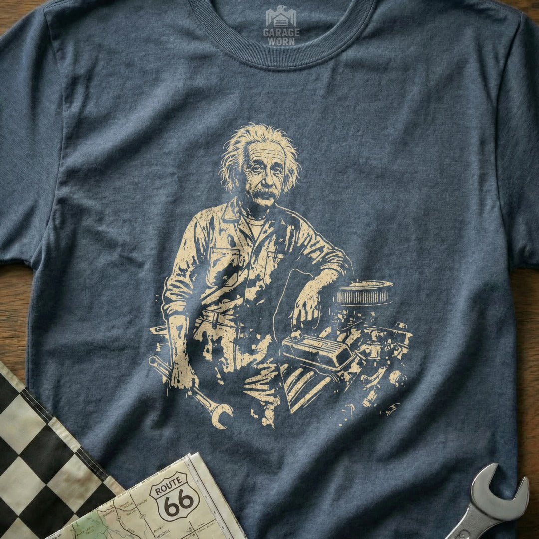 Albert Einstein leaning on an engine, holding tools, with Route 66 map.