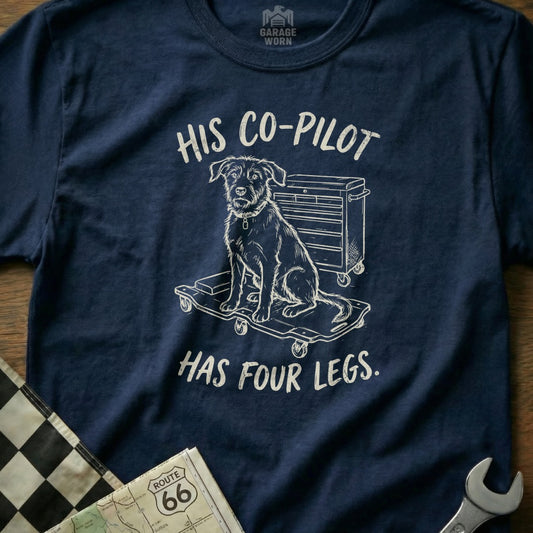 Navy t-shirt with illustration of dog on toolbox, text reads "HIS CO-PILOT HAS FOUR LEGS."