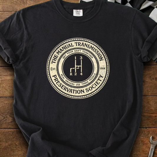 Manual Transmission Preservation Society graphic with gear shift pattern and "Real Drivers Use Three Pedals."