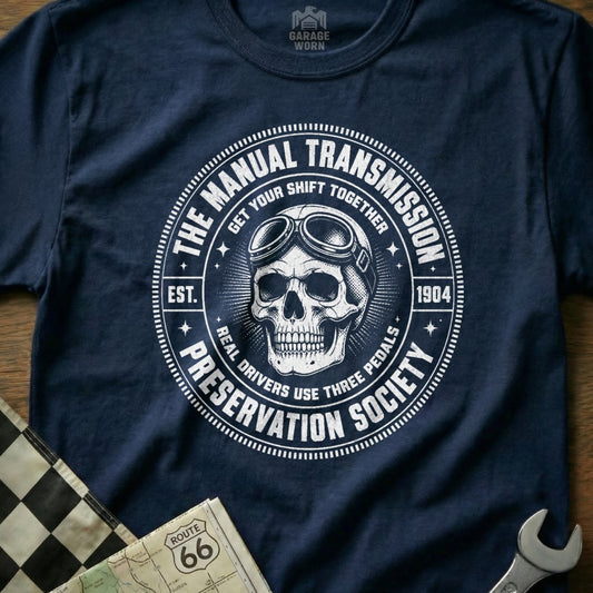 Navy t-shirt with skull and goggles graphic for "The Manual Transmission Preservation Society".