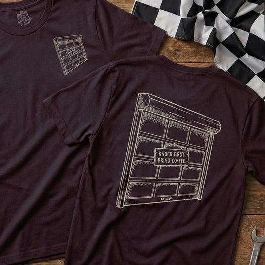 Burgundy t-shirt with garage door graphic and "Knock First. Bring Coffee." text.