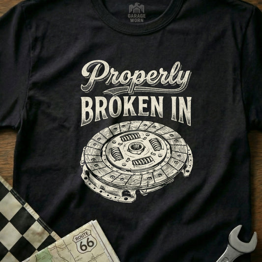 Black t-shirt with "Properly Broken In" text and a clutch disc illustration.