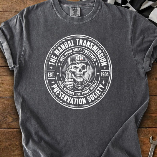 Dark gray t-shirt with circular graphic: "The Manual Transmission Preservation Society".