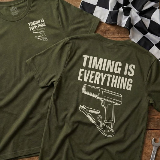 Green t-shirt with "Timing is Everything" and a spark plug graphic.