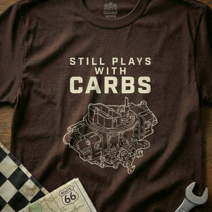 Brown t-shirt with "Still Plays With Carbs" and a detailed carburetor illustration.