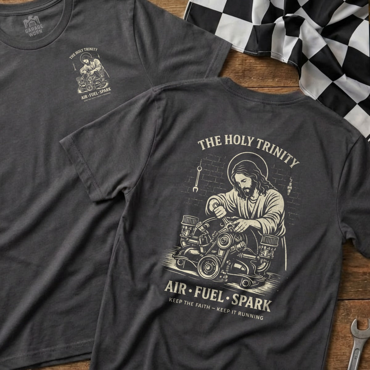 T-shirt with "The Holy Trinity" and Jesus working on an engine.