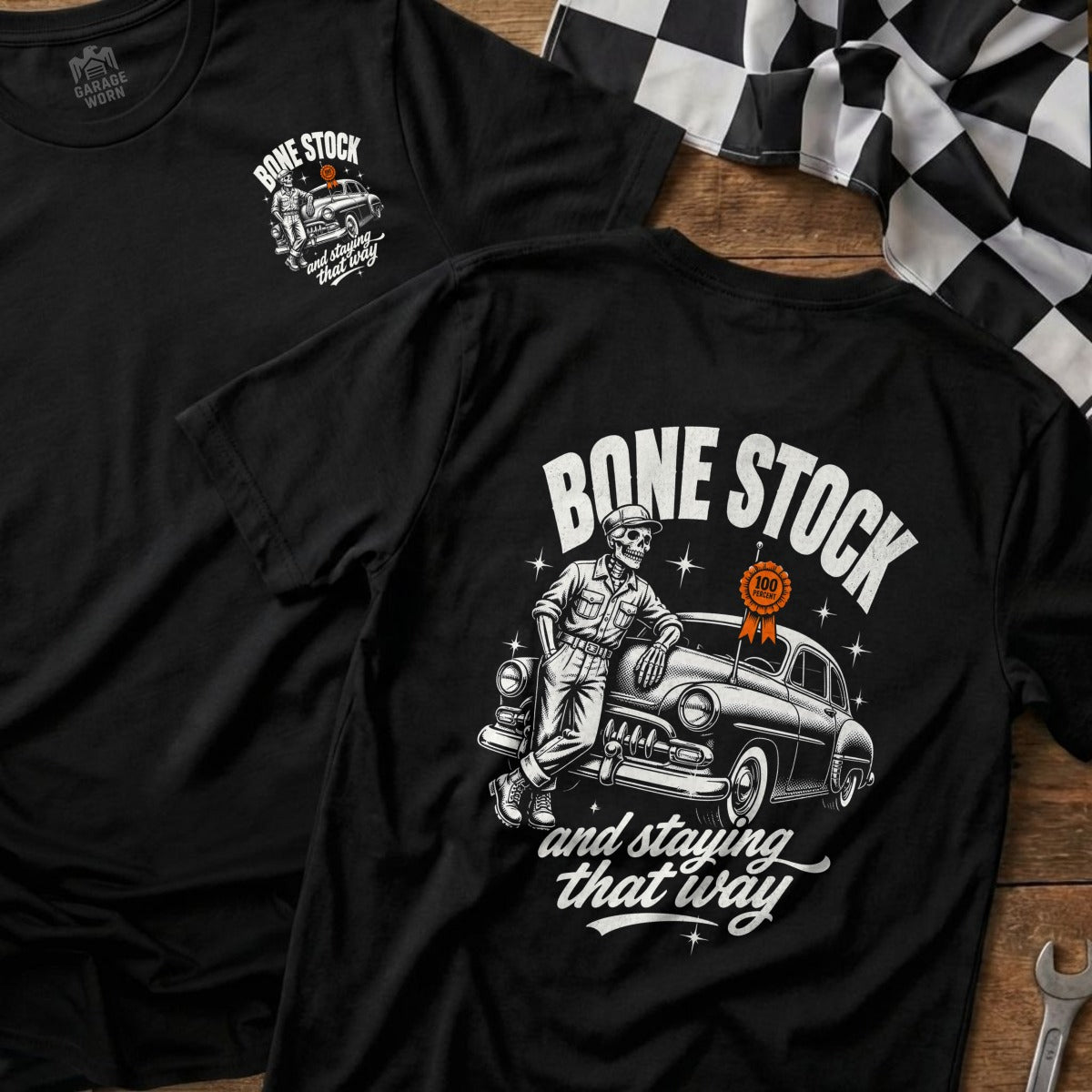 Black t-shirt with skeleton leaning on a vintage car and text "Bone Stock and staying that way".