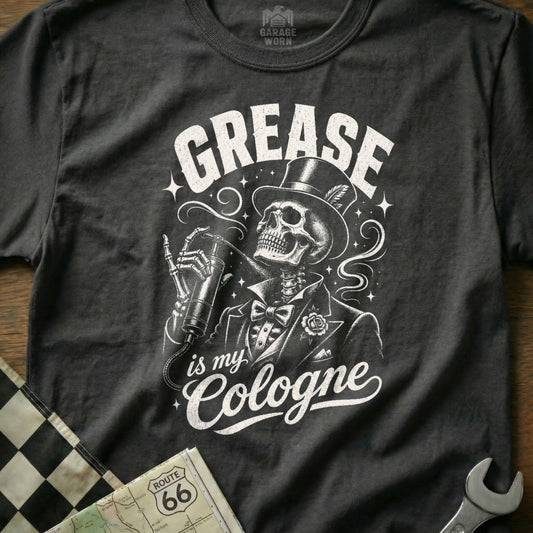 Dark t-shirt with graphic of skeleton in tuxedo with hat, holding spray bottle, reading "GREASE is my Cologne".