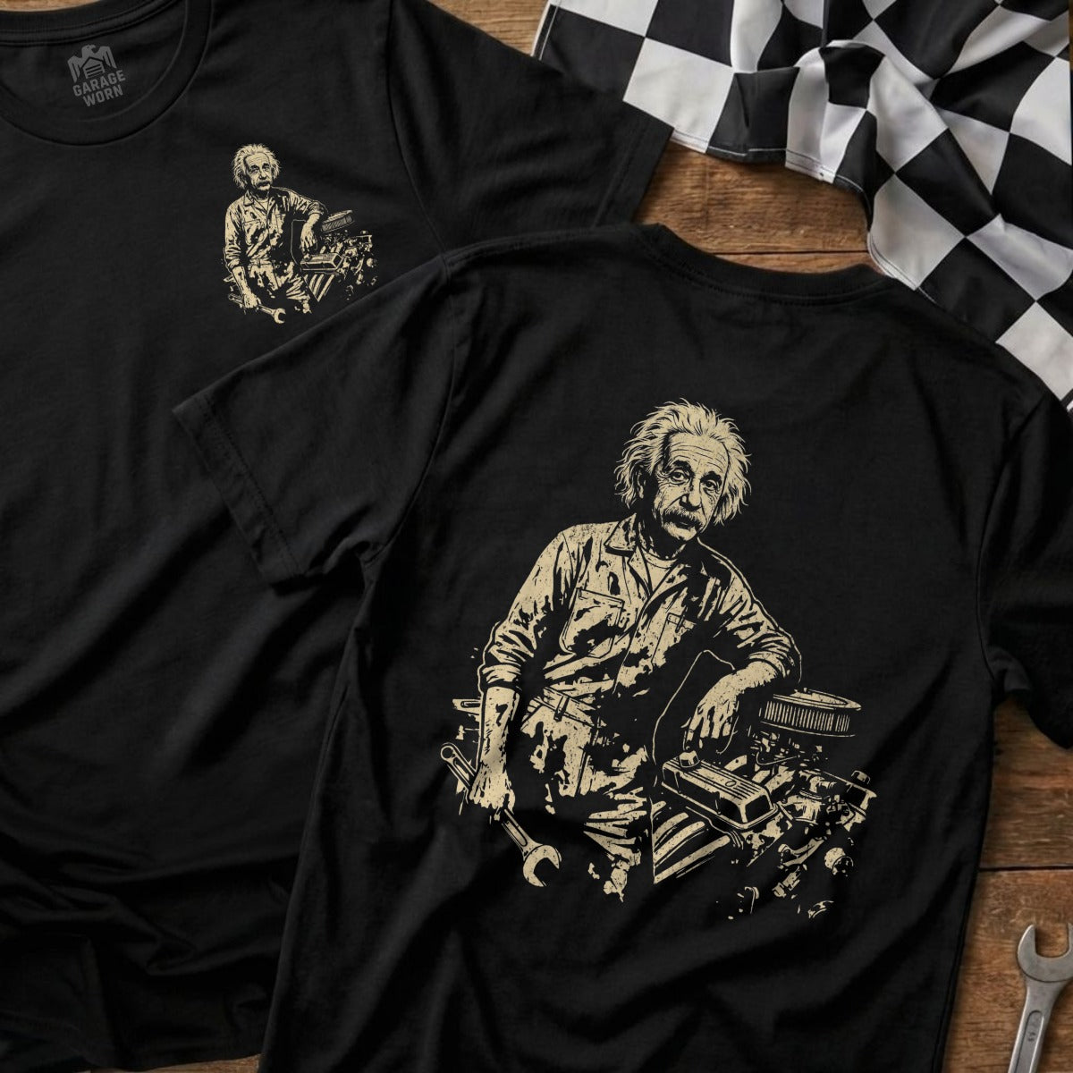 Albert Einstein leans on a car engine on a black t-shirt.