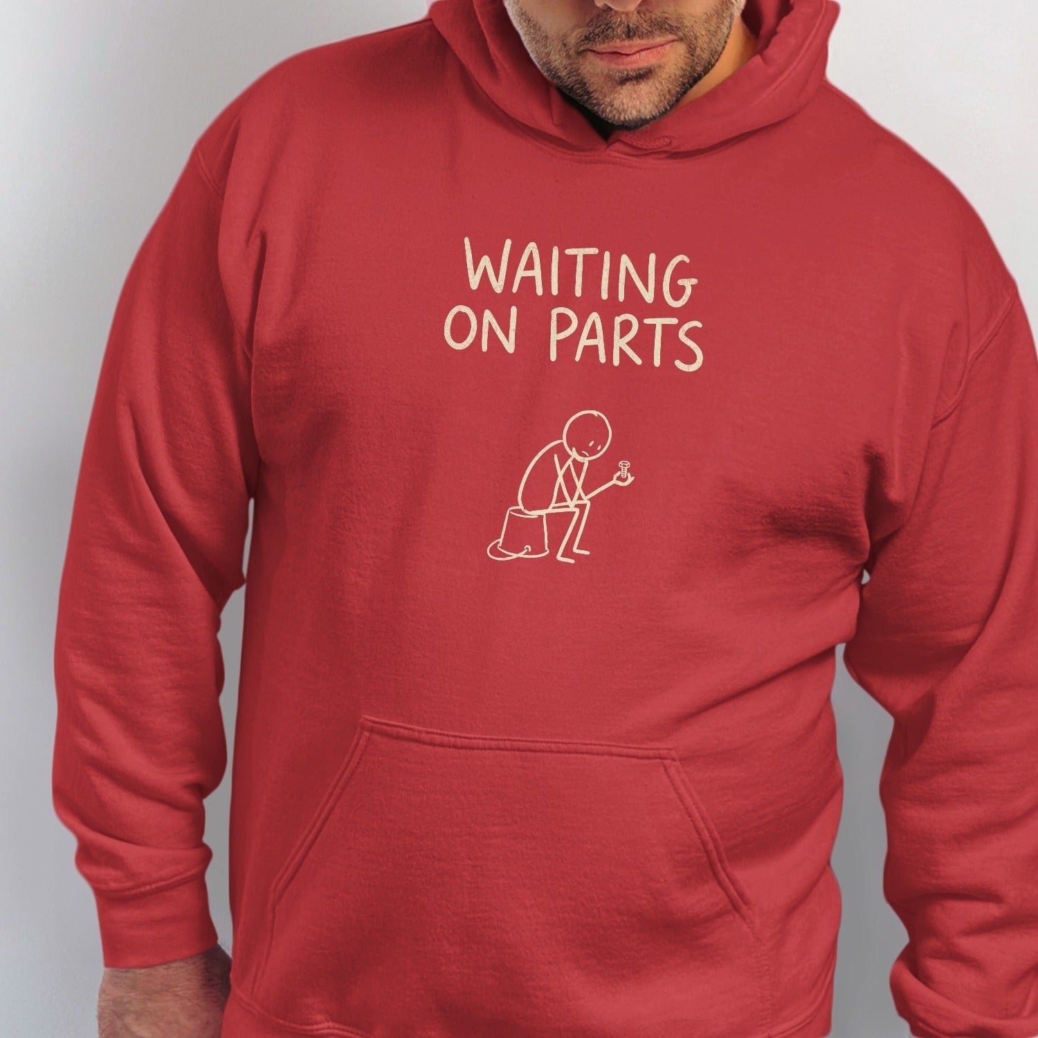 Red hoodie with "WAITING ON PARTS" text and stick figure holding a screw.