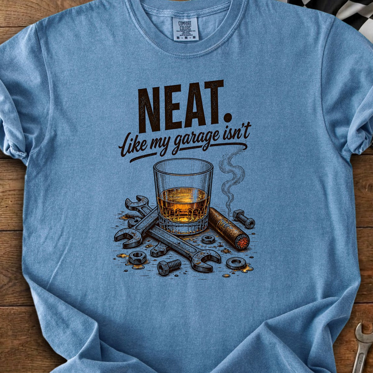 "Neat. Like my garage isn't" text with whiskey, cigar, nuts, and wrenches.