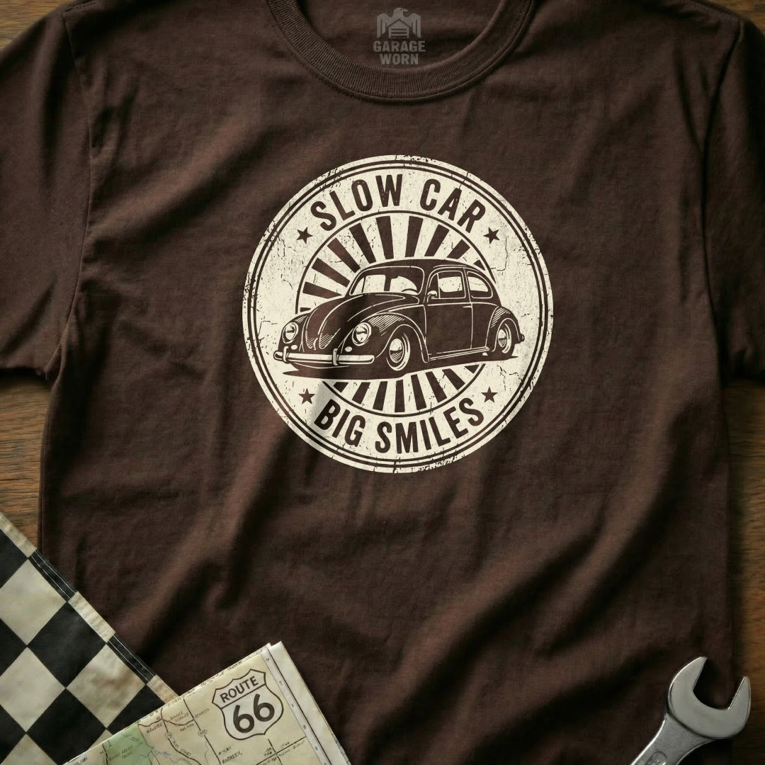 Brown t-shirt with distressed circular graphic: "SLOW CAR BIG SMILES" and a vintage VW Beetle.