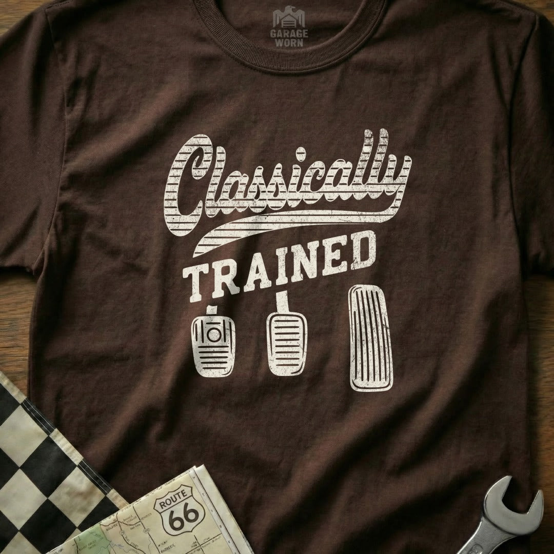Brown t-shirt with "Classically Trained" and car pedals graphic.