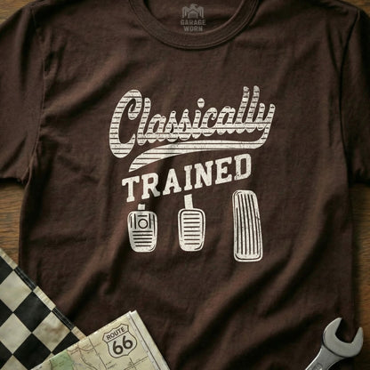 Brown t-shirt with "Classically Trained" and car pedals graphic.