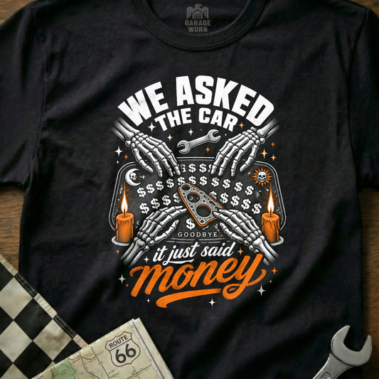T-shirt graphic: "We Asked The Car, It Just Said Money" with skeleton hands and Ouija board.