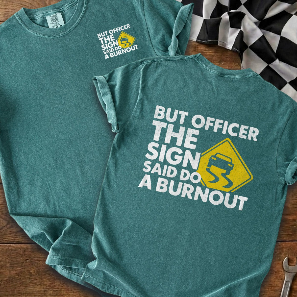Teal t-shirt with "But officer the sign said do a burnout" text and slippy road icon.