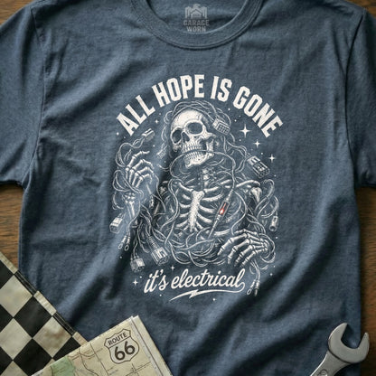 Skeleton tangled in wires on a shirt with "ALL HOPE IS GONE it's electrical".