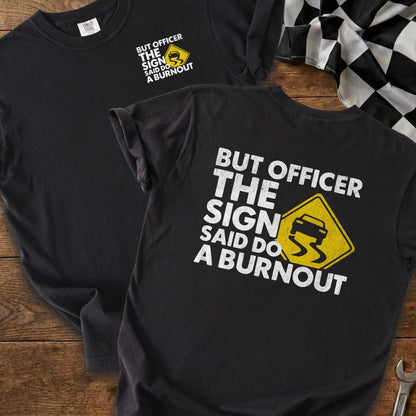 Black t-shirt with slogan "But officer, the sign said do a burnout" and a car icon.
