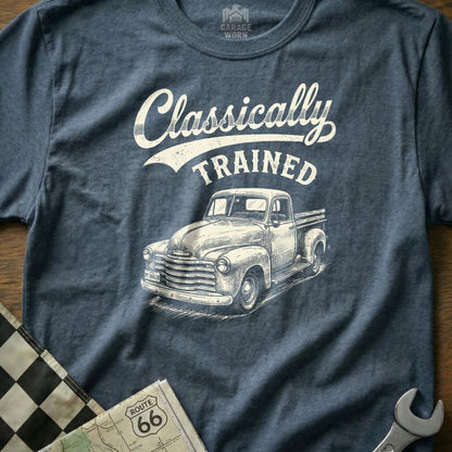"Classically Trained" text with a vintage truck graphic on a blue heather t-shirt.